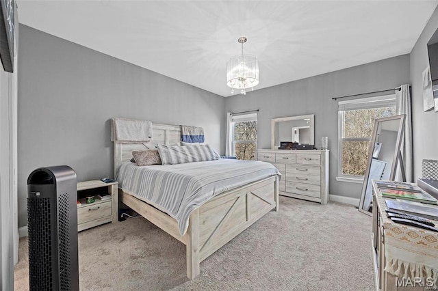 4028 Montague Cir Unit 4, Saint Charles, MO 63304 - bedroom featuring light carpet, a chandelier, and multiple windows