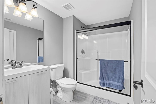 4028 Montague Cir Unit 4, Saint Charles, MO 63304 - full bathroom featuring a stall shower, vanity, toilet, and wood finished floors