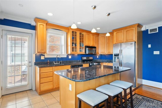 7570 Byron Pl Unit 3E, Saint Louis, MO 63105 - kitchen featuring stainless steel appliances, crown molding, a kitchen breakfast bar, glass insert cabinets, and a sink