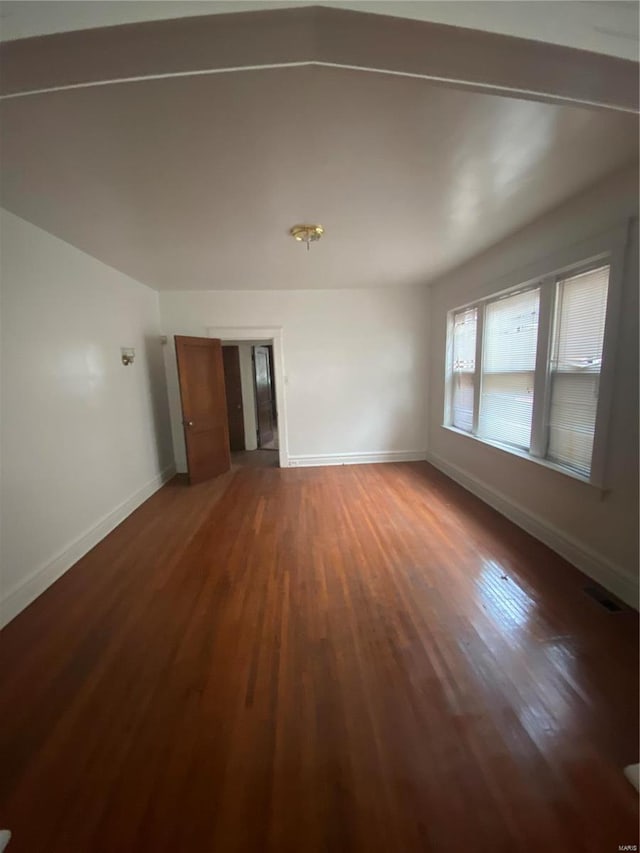 5451 Queens Ave, Saint Louis, MO 63115 - unfurnished living room featuring wood finished floors and baseboards
