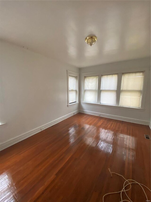 5451 Queens Ave, Saint Louis, MO 63115 - spare room featuring baseboards and dark wood-style floors