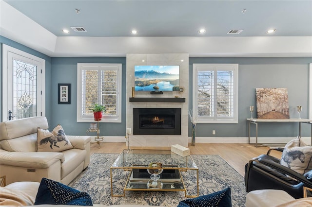 4411 Mcpherson Ave Unit 3, Saint Louis, MO 63108 - living room with a tile fireplace, wood finished floors, baseboards, and recessed lighting