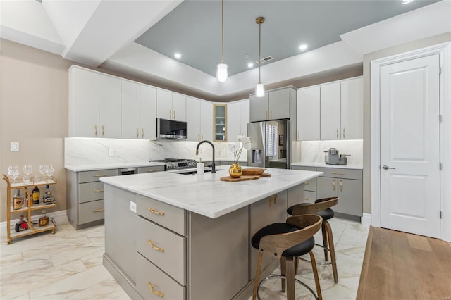 4411 Mcpherson Ave Unit 3, Saint Louis, MO 63108 - kitchen featuring stainless steel appliances, light marble finish floors, gray cabinets, backsplash, and recessed lighting