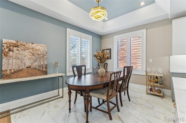 4411 Mcpherson Ave Unit 3, Saint Louis, MO 63108 - dining room featuring light marble finish floors, a tray ceiling, baseboards, and recessed lighting