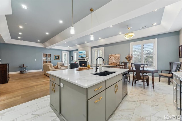 4411 Mcpherson Ave Unit 3, Saint Louis, MO 63108 - kitchen featuring a sink, a tray ceiling, light marble finish flooring, baseboards, and recessed lighting