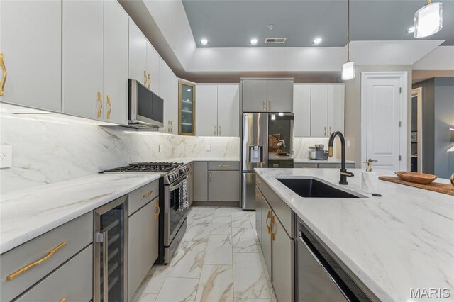 4411 Mcpherson Ave Unit 3, Saint Louis, MO 63108 - kitchen with a sink, wine cooler, appliances with stainless steel finishes, light marble finish floors, and gray cabinets