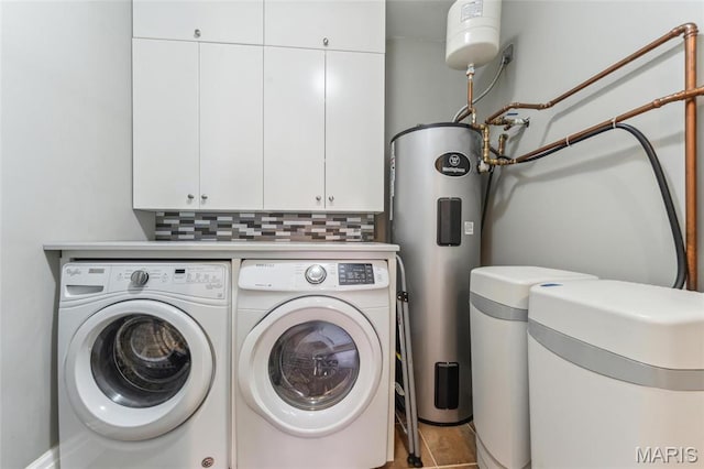 4411 Mcpherson Ave Unit 3, Saint Louis, MO 63108 - laundry area featuring washing machine and dryer, cabinet space, and electric water heater
