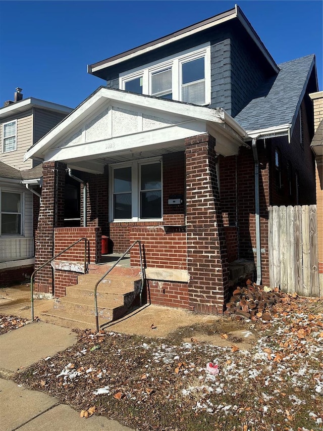 3923 Gravois Ave, Saint Louis, MO 63116 - view of front of property featuring a porch, brick siding, and fence