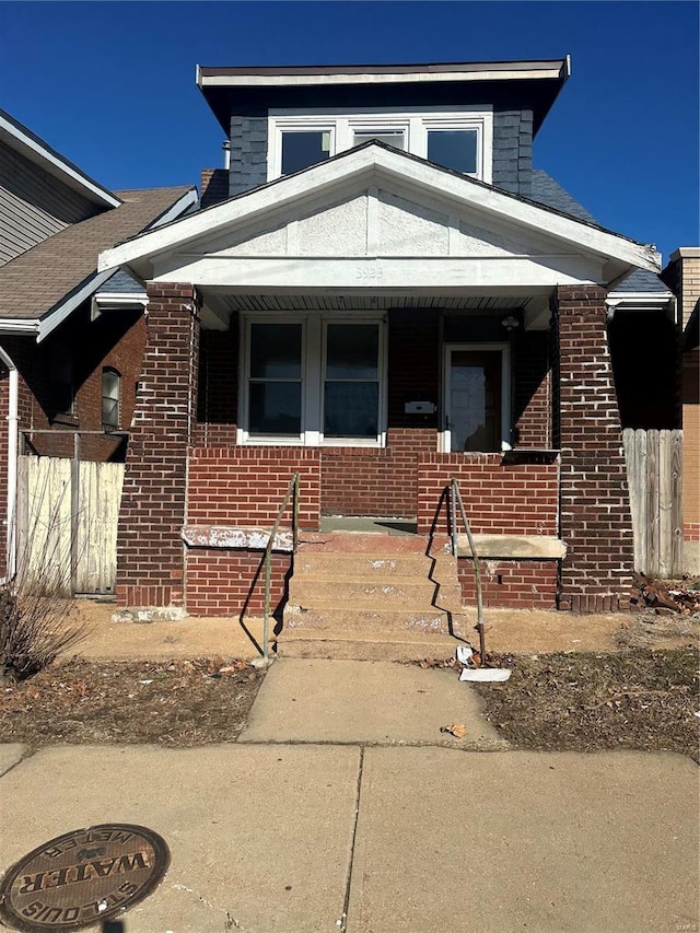 3923 Gravois Ave, Saint Louis, MO 63116 - view of front facade featuring a porch and brick siding