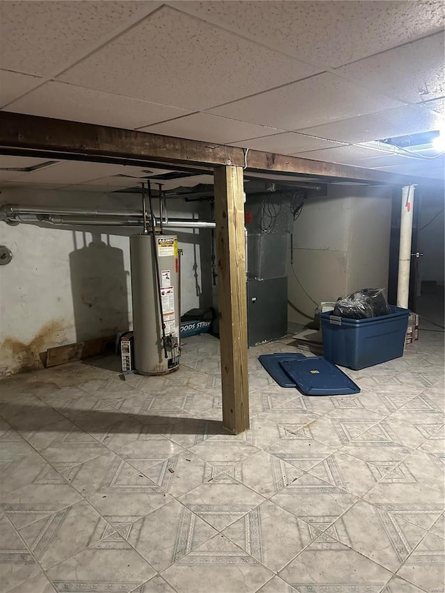 3923 Gravois Ave, Saint Louis, MO 63116 - unfinished basement featuring water heater, a paneled ceiling, and tile patterned floors
