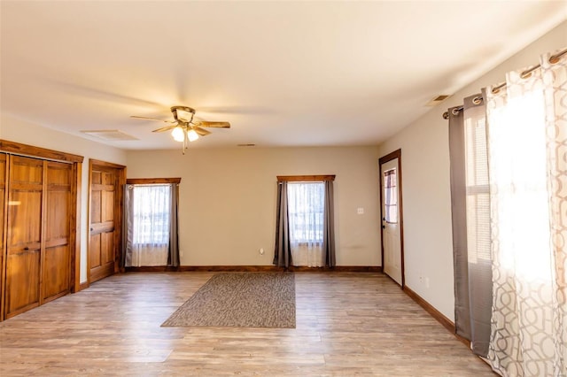 entrance foyer featuring a ceiling fan, light wood-type flooring, and baseboards
