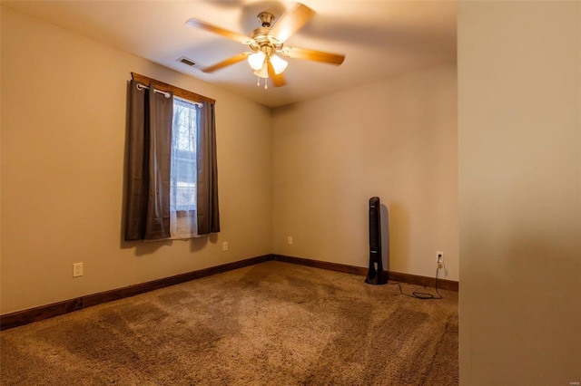 carpeted empty room featuring a ceiling fan and baseboards