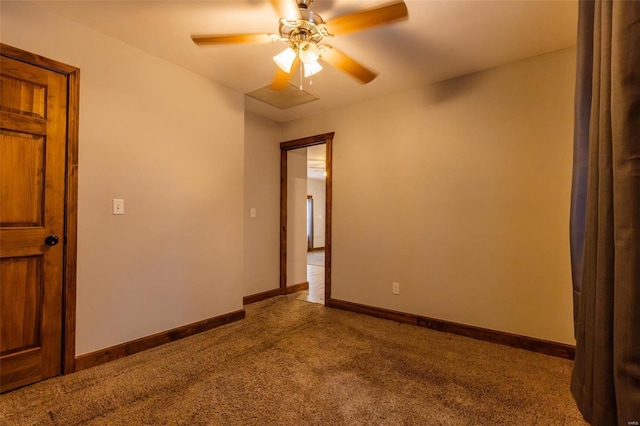 empty room with carpet floors, ceiling fan, and baseboards