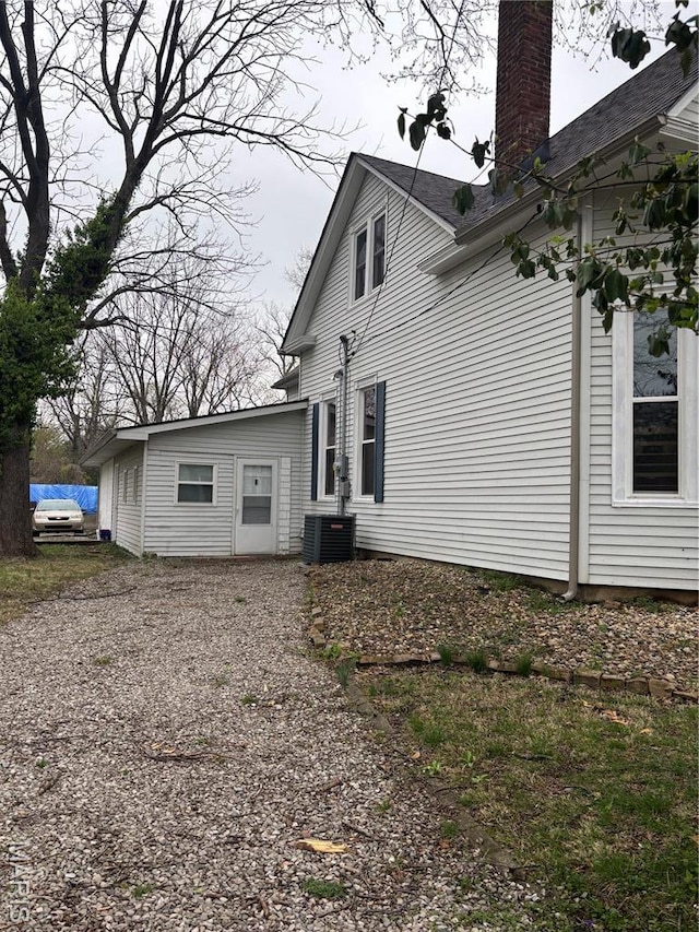 911 Grand Ave, Edwardsville, IL 62025 - back of house with a chimney and central AC
