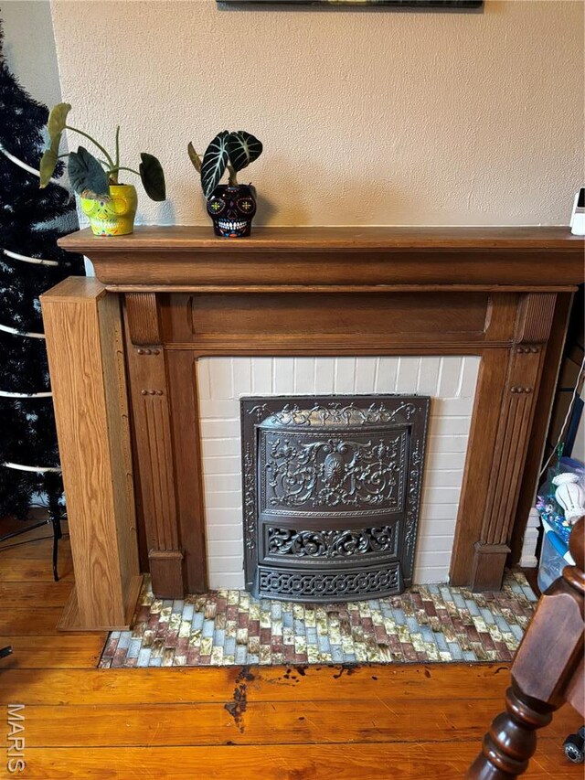 911 Grand Ave, Edwardsville, IL 62025 - detailed view of a tiled fireplace and wood finished floors