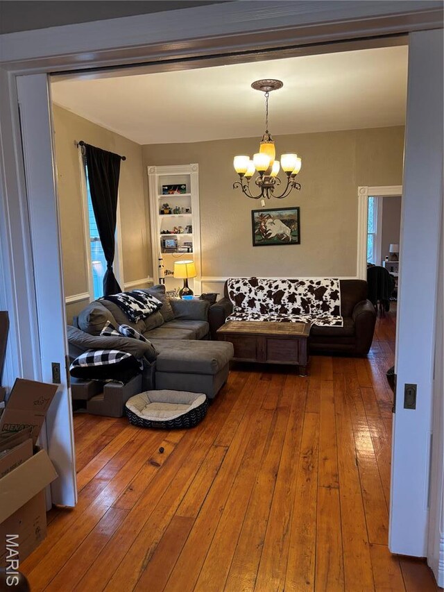 911 Grand Ave, Edwardsville, IL 62025 - living area featuring a chandelier, hardwood / wood-style flooring, and built in shelves