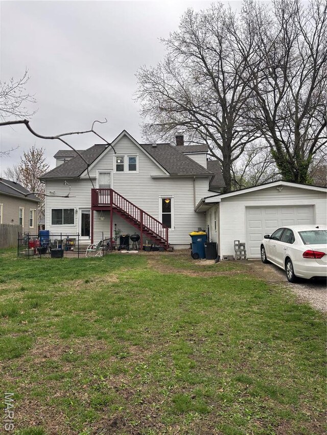 911 Grand Ave, Edwardsville, IL 62025 - back of property featuring a shingled roof, a detached garage, and a chimney