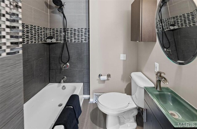 911 Grand Ave, Edwardsville, IL 62025 - bathroom featuring toilet, vanity, bathtub / shower combination, and baseboards
