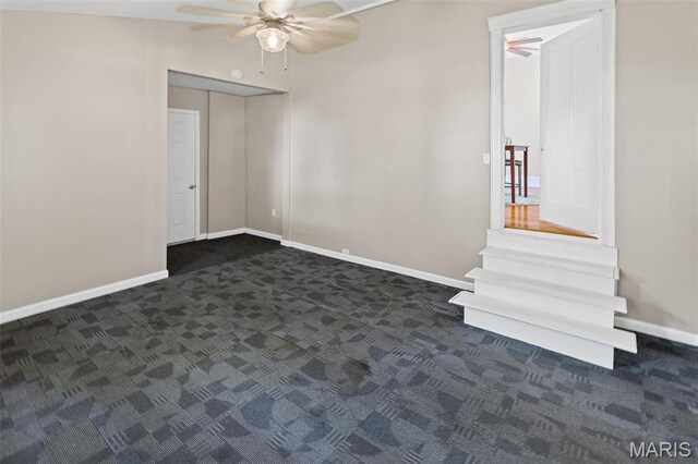 911 Grand Ave, Edwardsville, IL 62025 - empty room with a ceiling fan, dark carpet, and baseboards
