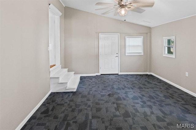 911 Grand Ave, Edwardsville, IL 62025 - foyer with a ceiling fan, dark colored carpet, vaulted ceiling, and baseboards