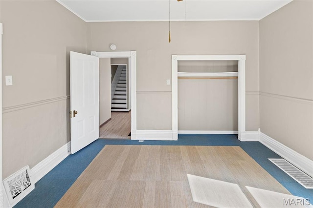 911 Grand Ave, Edwardsville, IL 62025 - unfurnished bedroom with a closet, baseboards, and ornamental molding