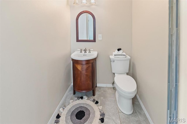 911 Grand Ave, Edwardsville, IL 62025 - bathroom with toilet, tile patterned floors, vanity, and baseboards