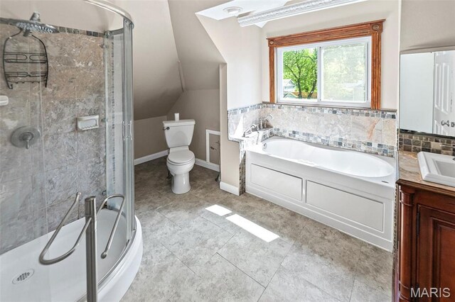 911 Grand Ave, Edwardsville, IL 62025 - bathroom with a stall shower, vanity, toilet, a garden tub, and vaulted ceiling