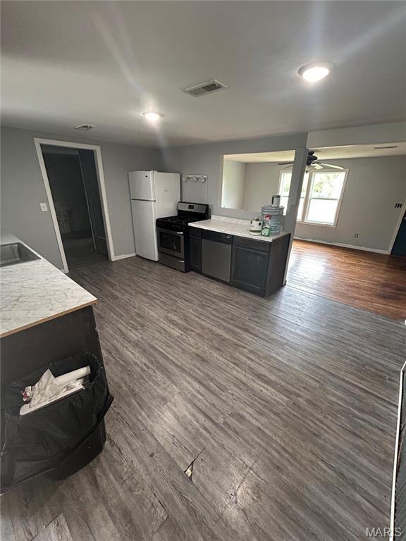 308 N Broadwater St, New Florence, MO 63363 - kitchen with gas range, freestanding refrigerator, light countertops, and baseboards