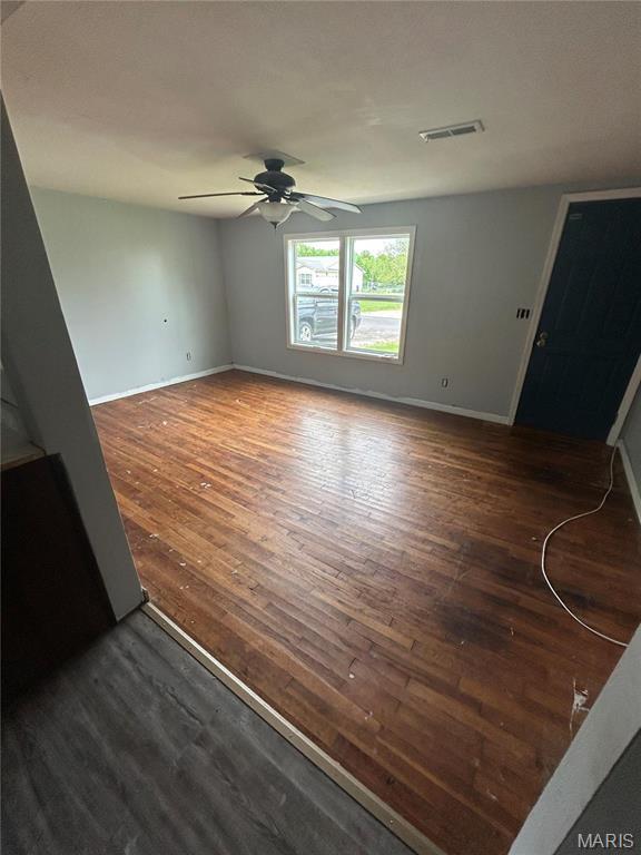 308 N Broadwater St, New Florence, MO 63363 - unfurnished living room featuring ceiling fan, wood-type flooring, and baseboards