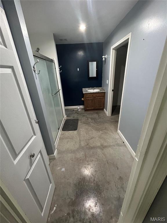 308 N Broadwater St, New Florence, MO 63363 - bathroom with a stall shower, vanity, unfinished concrete floors, and baseboards