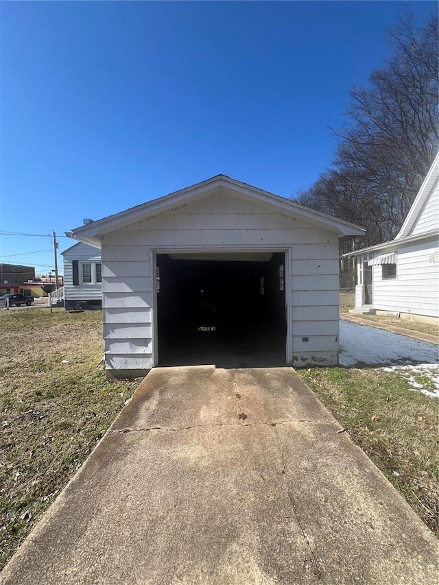 detached garage with concrete driveway