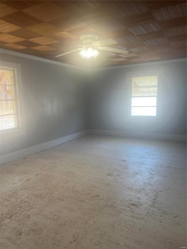 spare room with baseboards, ceiling fan, and ornamental molding