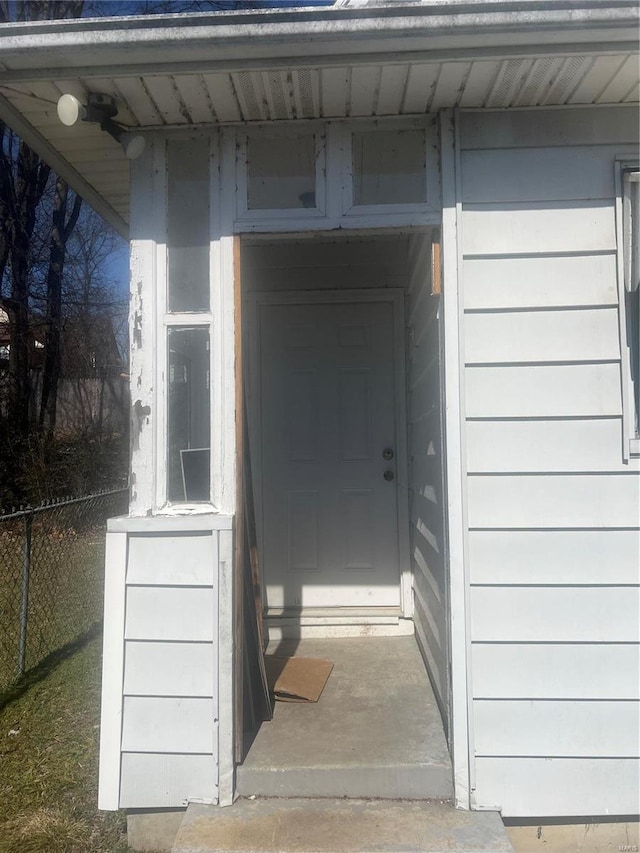 doorway to property with fence