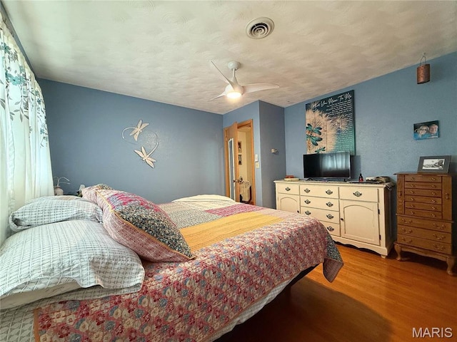 134 Pine St, Farmington, MO 63640 - bedroom featuring wood finished floors, ceiling fan, and a textured ceiling