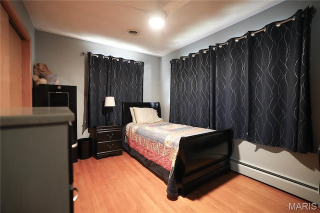 134 Pine St, Farmington, MO 63640 - bedroom with a baseboard heating unit and light wood-style flooring