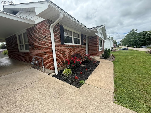134 Pine St, Farmington, MO 63640 - view of home's exterior with brick siding, a lawn, and driveway