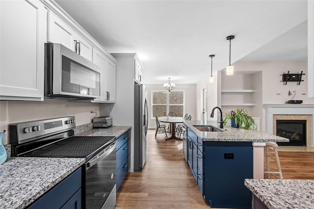 948 Half Moon, Caseyville, IL 62232 - kitchen with appliances with stainless steel finishes, blue cabinets, a sink, and a kitchen breakfast bar