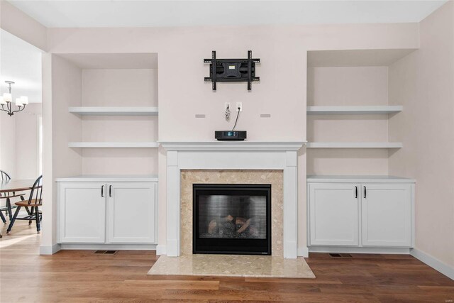 948 Half Moon, Caseyville, IL 62232 - detailed view of wood finished floors, a chandelier, baseboards, and a fireplace