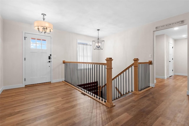 948 Half Moon, Caseyville, IL 62232 - foyer with a chandelier, wood finished floors, plenty of natural light, and baseboards