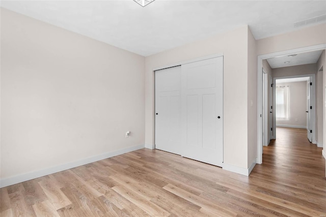 948 Half Moon, Caseyville, IL 62232 - unfurnished bedroom with light wood finished floors, baseboards, and a closet