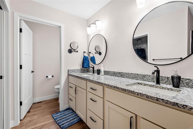 948 Half Moon, Caseyville, IL 62232 - bathroom with wood finished floors, toilet, baseboards, and double vanity