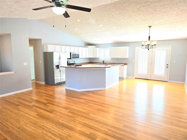 15872 Tundra St, Saint Robert, MO 65584 - kitchen with appliances with stainless steel finishes, a textured ceiling, white cabinets, a chandelier, and light wood finished floors