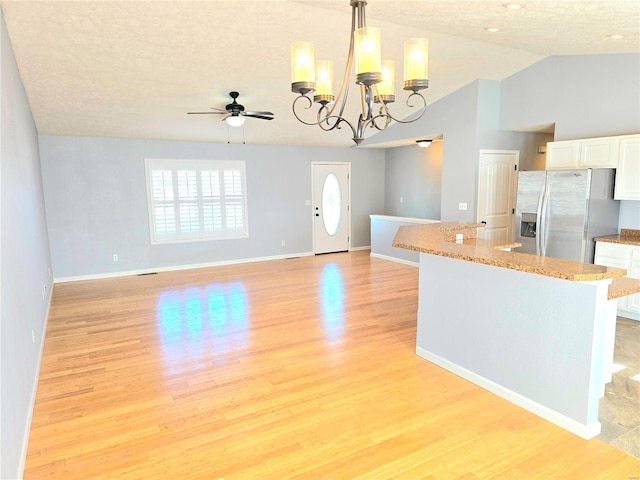 15872 Tundra St, Saint Robert, MO 65584 - kitchen with stainless steel fridge, white cabinetry, light wood finished floors, pendant lighting, and ceiling fan