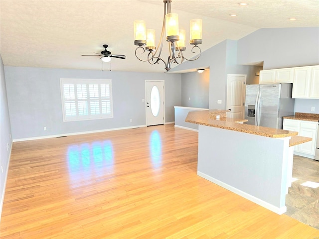 15872 Tundra St, Saint Robert, MO 65584 - kitchen featuring stainless steel refrigerator with ice dispenser, white cabinets, ceiling fan, a center island, and high vaulted ceiling