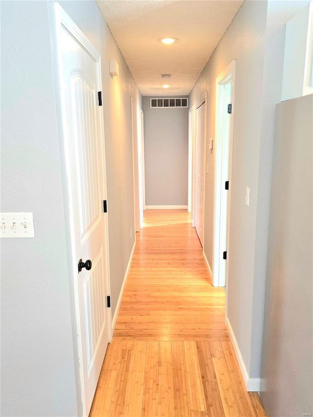 15872 Tundra St, Saint Robert, MO 65584 - hall with light wood-style floors, baseboards, and recessed lighting