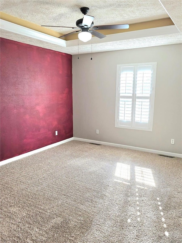 15872 Tundra St, Saint Robert, MO 65584 - unfurnished room featuring ceiling fan, carpet, baseboards, a textured ceiling, and a raised ceiling
