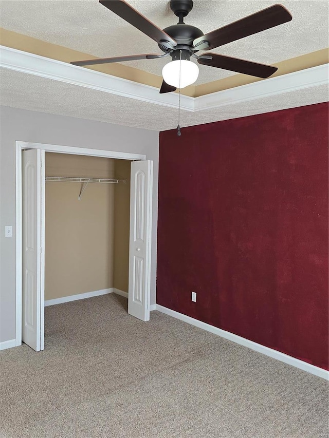 15872 Tundra St, Saint Robert, MO 65584 - unfurnished bedroom with carpet, a closet, baseboards, a textured ceiling, and a ceiling fan