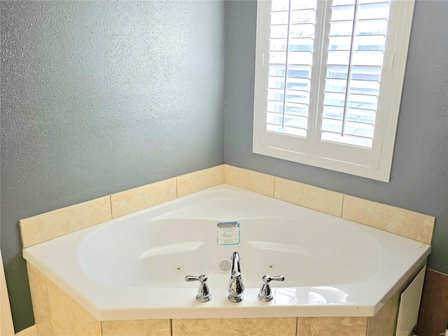 15872 Tundra St, Saint Robert, MO 65584 - full bath with a whirlpool tub and a textured wall