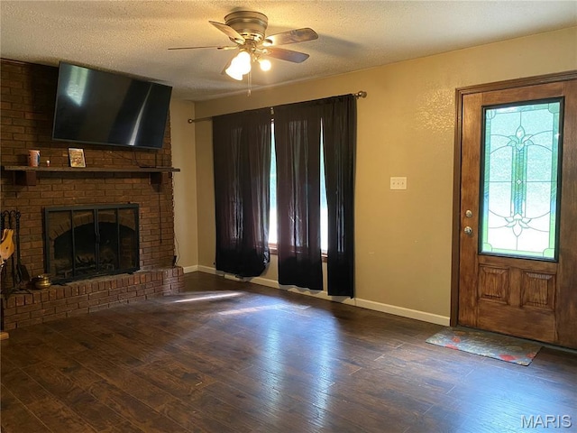 207 Navaho Dr, Cape Girardeau, MO 63701 - foyer entrance with ceiling fan, wood finished floors, a textured ceiling, and a fireplace