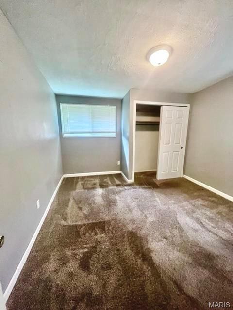 750 Robinwood Dr, Florissant, MO 63033 - unfurnished bedroom featuring carpet floors, a closet, and a textured ceiling